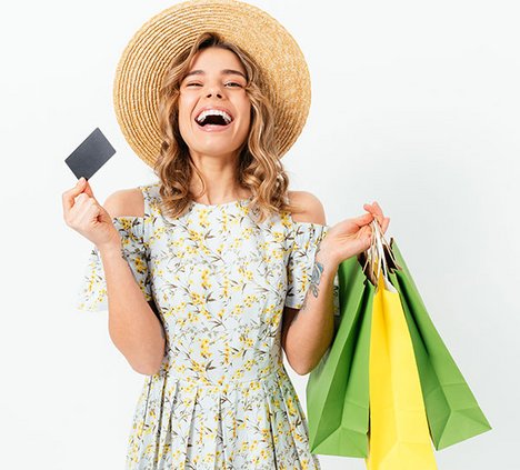 Laughing woman holding a voucher in her hand 